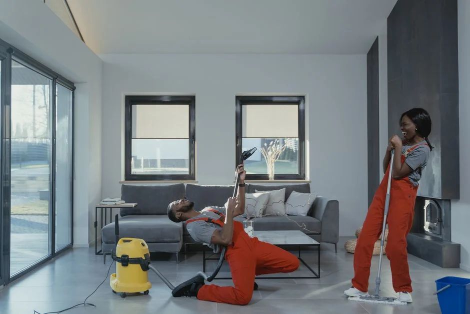 A couple collaboratively lifting a couch while moving into a new apartment.
